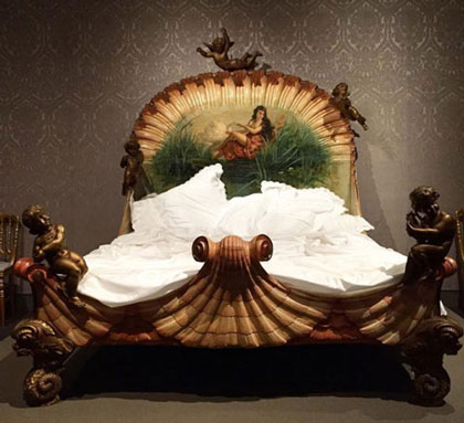 extravagant style of bed with shell motif headboard