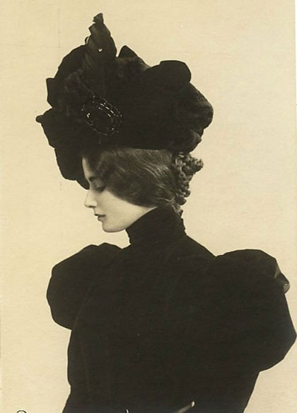 sepia tone photo of famous Parisian celebrity, female in profile, in dark clothing and hat