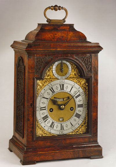 walnut bracket clock with gold and white dia, handle on top