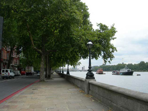 colour photo of river embankment, paved with trees