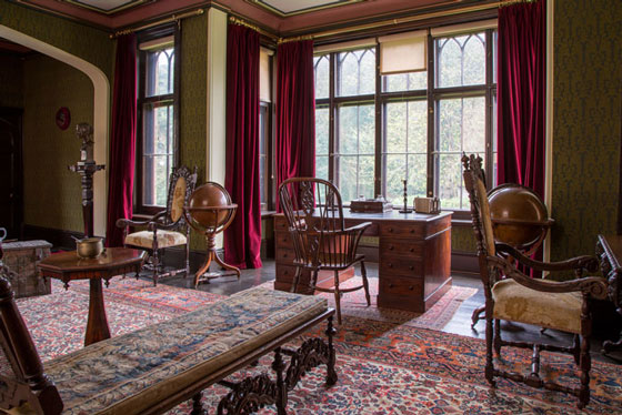 Victorian interior of Farringford House library showing writers desk and window