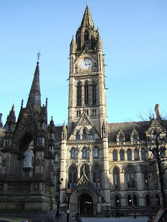 exterior of town hall with tall clock tower, Gothic revival style
