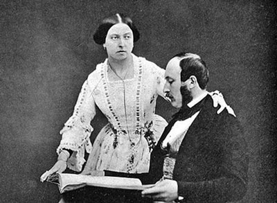 Victorian couple, Queen and Prince Albert, he seated reading