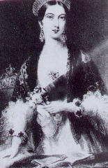 young woman in Victorian fashions with small flowers in hand