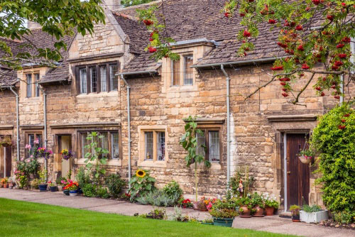 terrace of old stone buildings with lawn
