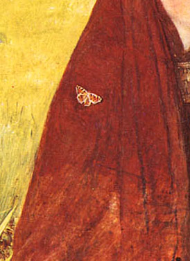 close up of the young woman's red dress shows butterfly resting