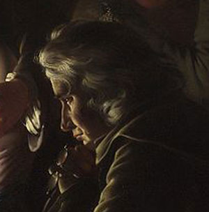 face of man deep in thought, profile, dark background