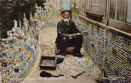 elderly gentleman seated amid elaborate sculptures of shells