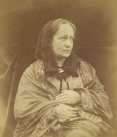 old photo in sepia tone of woman in shawl glancing sideways