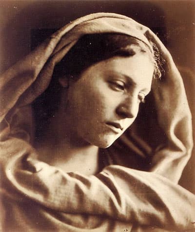 close up sepia tone photo of young woman with downcast gaze, half profile