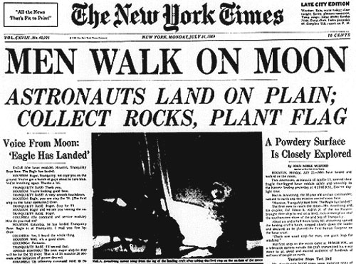 newspaper with headline that man walks on moon