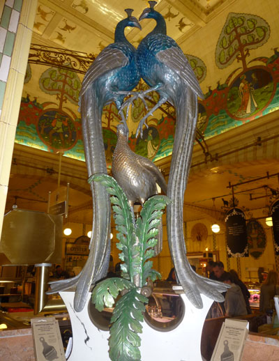 a glazed sculpture of peacocks 