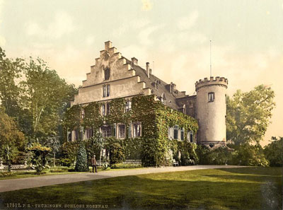 postcard image of old Germanic castle building with lawns and trees