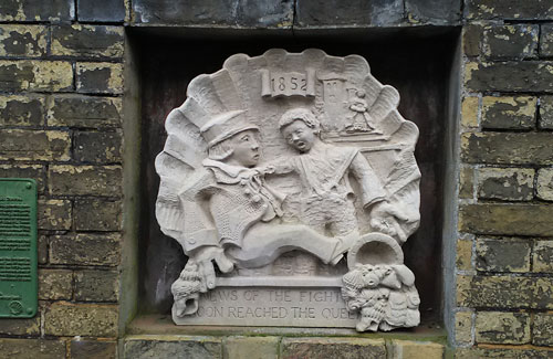 relief sculpture showing two boys brawling