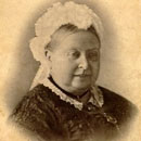 small sepia tone image shows face of Queen Victoria smiling