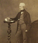 thumbnail image of photo, sepia tone, of elderly Victorian gentleman, standing